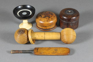 A miniature treen cricket bat 4", a carved ebony and ivory pedestal bowl 2", 2 turned wooden jars and covers and 1 other  item of treen