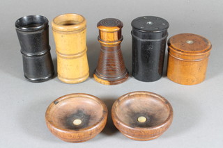 2 turned and waisted wooden die shakers, a turned lignum vitae caster 3", 2 wooden jars and covers and 2 turned wooden bowls
