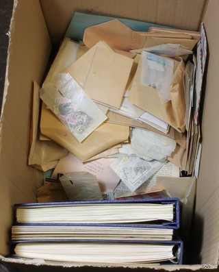 A box containing 2 stamps albums, 2 stock books and a  collection of various loose stamps