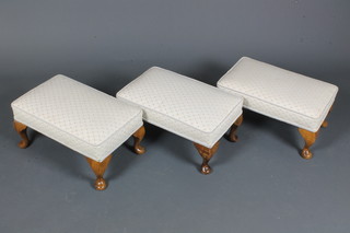 A near matching set of 3 beechwood framed footstools, having tapestry woven stuff over tops, raised on cabriole legs pad feet  9"h x 18.5"w x 12"d