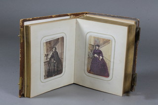 A Victorian leather bound photograph album containing various coloured photographs of the Royal Family