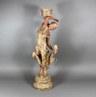An Art Nouveau style figural candlestick, study of a young  woman holding an urn in diaphanous robes, raised on socle base  26.5"h