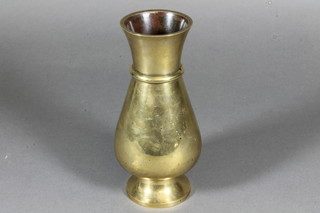 A baluster shaped bronze vase, raised on a spreading foot, the base with impressed marks 7"