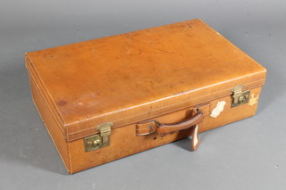 A tan brown leather suitcase with brass fittings 28" x 18" x 8"