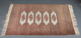 A brown ground Bokhara rug with 5 octagons to the centre  within multi-row border 59" x 38"