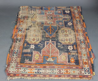 A Caucasian rug, heavily worn and holed, 119" x 49"