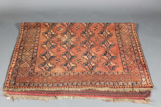 A red ground Afghan rug with 36 octagons to the centre 80" x  59"