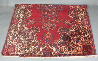 A red ground Persian Bakhtiara carpet with central medallion  116" x 81"