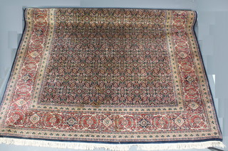 A Persian blue ground rug, the central field with all over floral design 120" x 96"