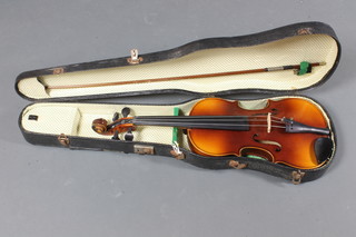 A violin, labelled Antonius Stradivarius Cremona Fecit Anno 17731, with 2 piece back 14", cased and with bow