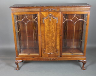 A 1920's mahogany display cabinet in the 18th Century style  with reeded frieze above a pair of arched bar glazed doors, raised  on cabriole legs, claw and ball feet 50.5"h x 54"w x 14.5"d