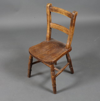A 19th Century oak and elm childs chair having ladder back  above a saddle seat, raised on turned legs