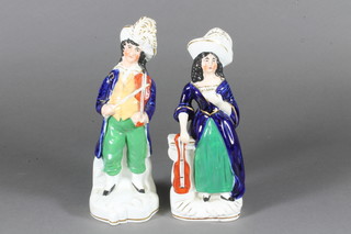 A pair of Staffordshire figures of a lady and gentleman violinist  7"