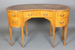 An Edwardian mahogany kidney shaped writing table, satinwood crossbanded, the top with brown leather gilt tooled skiver above  an arrangement of 5 drawers, raised on square tapered legs,  spade feet, 1 leg missing 28"h x 45"w x 22"d  ILLUSTRATED