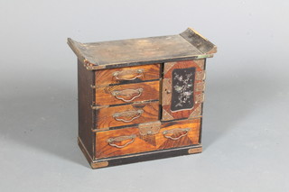 A Japanese late Meiji period Tansu, black lacquered and  parquetry decorated fitted 4 small drawers and cupboard door  enclosing a further small drawer, raised on plinth base 13.5"h x  15"w x 7.5"d