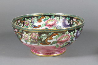 A circular Malingware pottery bowl with floral decoration 8.5"