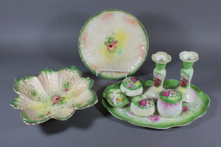 A 7 piece Edwardian green glazed pottery dressing table set comprising tray, pair of candlesticks, ring stand, 3 jars and  covers and matching straining dish