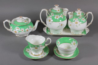 A Paragon 22 piece Narcissus green banded and floral patterned tea service comprising bread plate 9", 6 tea plates 7", rectangular  plate 12", teapot - lid f and r, 2 hot water jugs - 1 with chip to  interior rim, cream jug - cracked, sugar bowl, 6 saucers, 3 cups -  2 cracked, muffin dish lid 5.5"