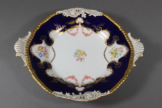A circular Coalport twin handled plate with gilt and garter blue  border and floral decoration - f and r, 11.5"