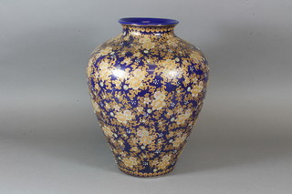 A blue glazed pottery vase with gilt floral decoration 13"