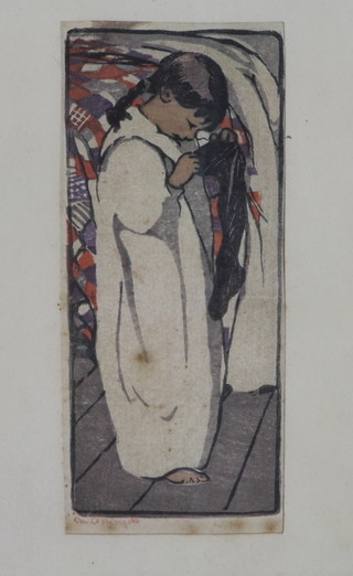 Mabel Alington Royds, British 1874-1941, a coloured wood  block print of a standing young girl inspecting her Christmas  stocking, signed in pencil to margin, 5.5"h x 2.5"w