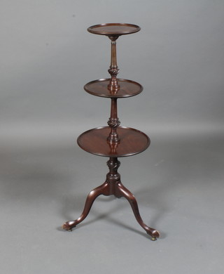 A Victorian mahogany 3 tier circular dumb waiter, the moulded tiers separated by tapered supports, raised on tripod base, slipper  feet, 42.5"h