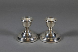 A pair of modern silver stub shaped candlesticks with bead work  borders 2.5"