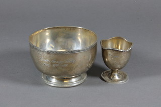 A circular silver sugar bowl, London 1962 together with a silver egg cup Birmingham 1923 4 ozs