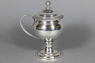 Aspreys, a silver Georgian style baluster shaped sifter, raised on a spreading foot, London 1911, 8 ozs  ILLUSTRATED