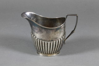 An Edwardian silver cream jug with demi-reeded decoration, Sheffield 1907 3 ozs