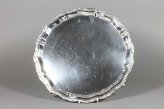 A Scotts silver salver with bracketed Celtic style border, raised  on 4 scroll supports, hallmarked Edinburgh 1969 , retailed by  Garrards, 18 ozs  ILLUSTRATED