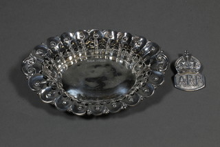 An oval pierced silver dish, Sheffield 1906 by James Dixon  together with a silver ARP badge