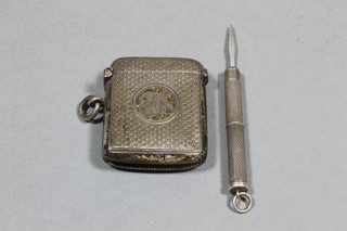 A silver vesta case with engraved decoration Chester 1904 and a silver cased toothpick