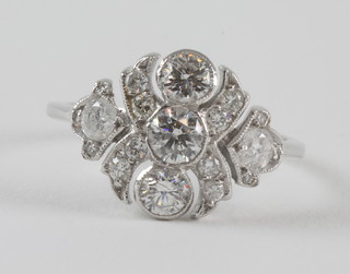 An 18ct white gold dress ring set 3 diamonds supported by  diamonds