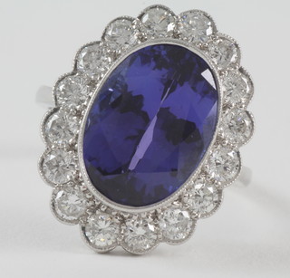 An 18ct white gold dress ring set a large oval tanzanite  surrounded by diamonds, approx 10.20ct/1.80ct
