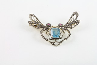 A gold bar brooch in the form of a butterfly set rubies, diamond, aquamarine