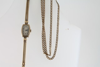 A lady's wristwatch contained in a gold case and a gilt metal flat link chain