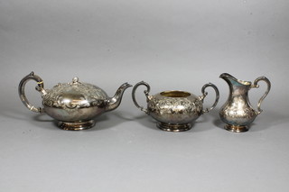 A circular engraved silver plated 3 piece tea service comprising teapot, twin handled sugar bowl and cream jug