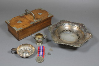 A rectangular oak and silver plated cigarette box 9.5", a circular pierced silver plated dish 8.5", a wine taster, a small silver  trophy cup and a WWII British war medal