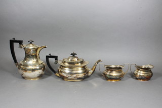 An oval silver plated 4 piece tea service comprising teapot, hotwater jug, twin handled sugar bowl and cream jug