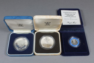 An Elizabeth II 1982 silver proof 20 pence piece, a 1981 silver proof Charles and Diana crown and a 1980 silver proof crown