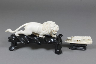 A carved ivory figure study a walking lion 5.5" together with a carved ivory study of an Oriental boat 3"