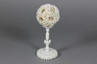 A carved ivory puzzle ball 1.5" and stand