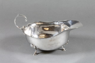 A silver sauce boat with C scroll handled and wavy border,  marks rubbed, 2 ozs