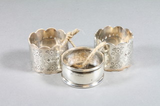 An Edwardian pair of engraved silver napkin rings, Sheffield  1905 and 1 other, 4 ozs,