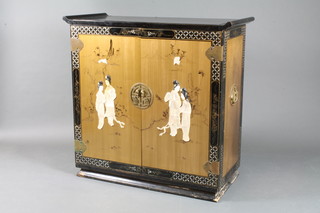 A Japanese black and gold lacquered side cabinet, the pair of cupboard doors inlaid with mother of pearl figures and enclosing  3 shelves, raised on plinth base, hole cut to back of cabinet  38"h x 40"w x 18"d