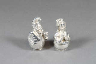 A pair of Victorian silver pepperettes in the form of Punch & Judy, London 1887, makers mark EHS, 8 ozs   ILLUSTRATED