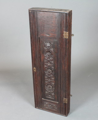 An unusual 19th Century oak wall mounted cupboard, the  moulded door centred with a foliate carved panel and inscribed  "Ye beeld from show and shine evqll menne to shield" and also  inscribed to interior "H M C, S Marcus 1896" 40.5"h x 14"w x  3.5"d