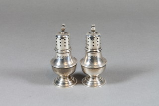 A pair of baluster shaped silver pepperettes, London 1921, 1 ozs