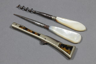 A pocket knife in the form of a rifle inlaid "tortoiseshell", f, together with a mother of pearl handled scent bottle corkscrew  and 1 other implement